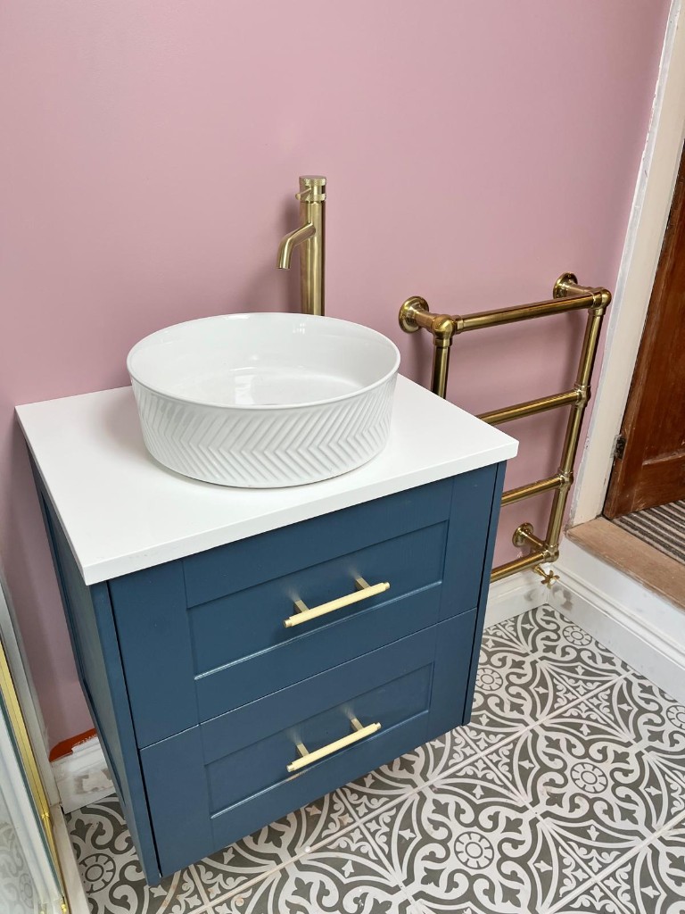 Navy bathroom vanity with gold tap and heated towel rail