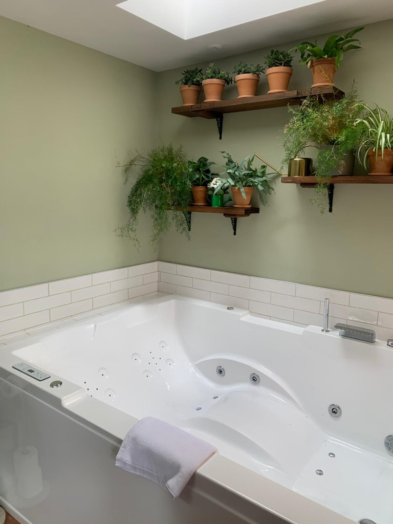 Whirlpool bath with chrome fittings and tiled walls